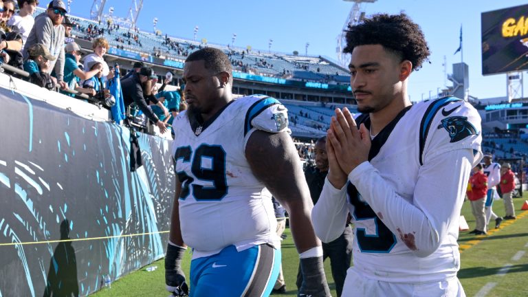 Carolina Panthers quarterback Bryce Young and guard Gabe Jackson leave the field after their loss against the Jacksonville Jaguars in an NFL football game Sunday, Dec. 31, 2023, in Jacksonville, Fla. (Phelan M. Ebenhack/AP)