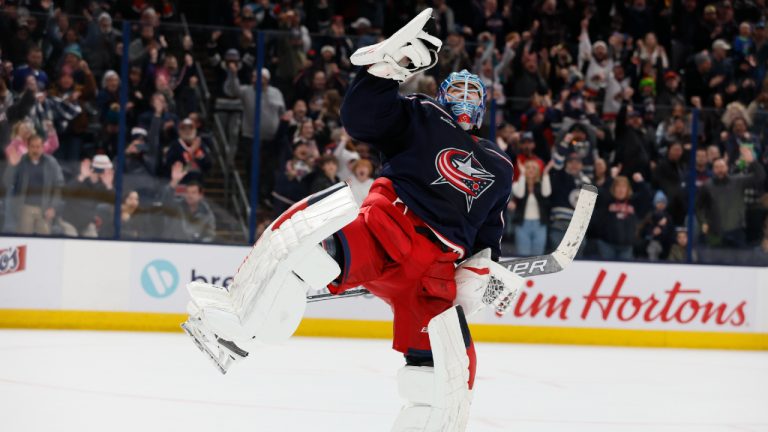 Columbus Blue Jackets' Elvis Merzlikins celebrates making a save to win their game against the Vancouver Canucks during the shootout of an NHL hockey game Monday, Jan. 15, 2024, in Columbus, Ohio. (Jay LaPrete/AP)