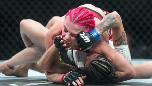Gillian Robertson, top, fights Polyana Viana during the Women's Strawweight bout at UFC 297 in Toronto on Saturday, January 20, 2024. (Nathan Denette/THE CANADIAN PRESS)