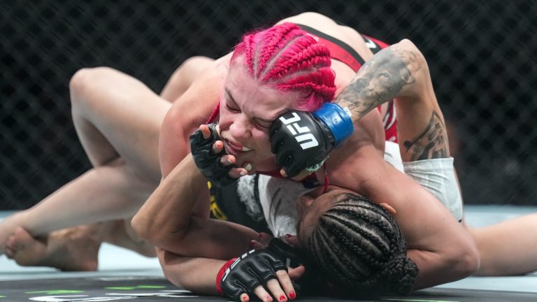 Gillian Robertson, top, fights Polyana Viana during the women's strawweight bout at UFC 297 in Toronto on Saturday, Jan. 20, 2024. (Nathan Denette/CP)