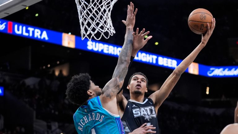 San Antonio Spurs center Victor Wembanyama (1) shoots over San Antonio Spurs guard Devonte' Graham (4) during the first half of an NBA basketball game in San Antonio, Friday, Jan. 12, 2024. (Eric Gay/AP)