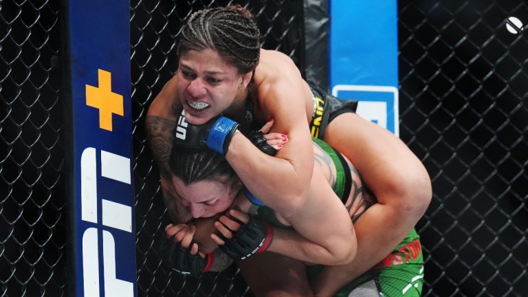 Raquel Pennington, bottom, fights Mayra Bueno Silva during a women's bantamweight title bout at UFC 297 in Toronto on Sunday, January 21, 2024. (Nathan Denette/THE CANADIAN PRESS)