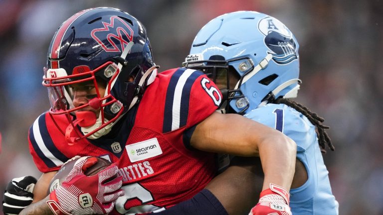 Montreal Alouettes wide receiver Tyson Philpot (6) tries to break the tackle from Toronto Argonauts linebacker Jordan Williams (1) during first half CFL Eastern Conference finals football action in Toronto on Saturday, November 11, 2023. (Nathan Denette/THE CANADIAN PRESS)