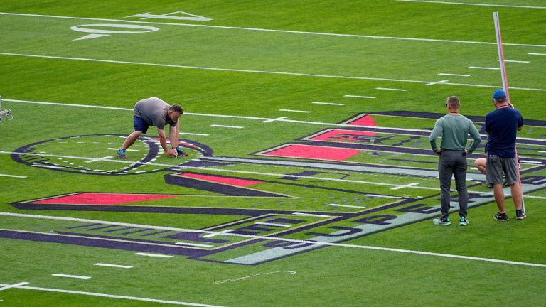Workers prepare the field outside Allegiant Stadium ahead of Super Bowl 58, Wednesday, Jan. 31, 2024, in Las Vegas. (AP Photo/Matt York)