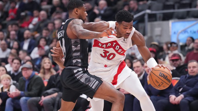 Toronto Raptors' Ochai Agbaji drives past San Antonio Spurs' Blake Wesley during second half NBA basketball action in Toronto on Monday, February 12, 2024. THE CANADIAN PRESS/Chris Young