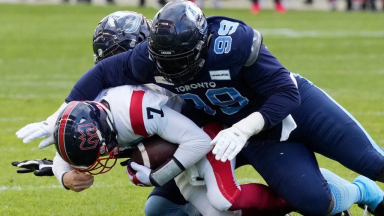Montreal Alouettes quarterback Trevor Harris (7) sacked by Toronto Argonauts defensive lineman Dewayne Hendrix (99) during first half CFL Eastern Final football action in Toronto on Sunday, Nov. 13, 2022. (CP)