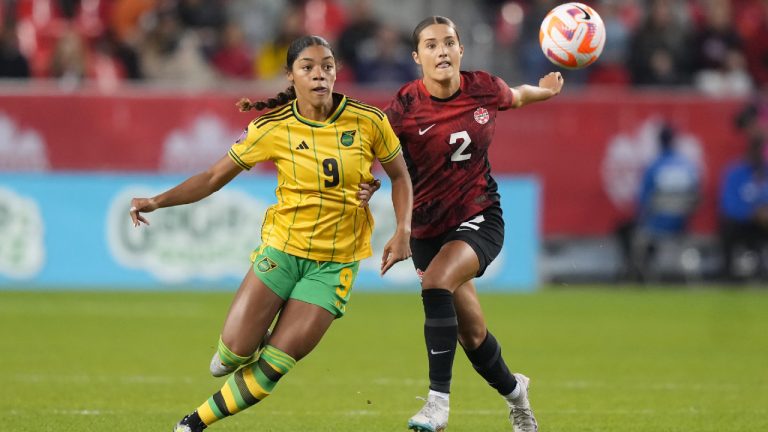 Canada's Sydney Collins battles Jamaica's Kameron Simmonds for the ball during first half CONCACAF women's championship soccer series match in Toronto on Tuesday Sept. 26, 2023. (Nathan Denette/CP)