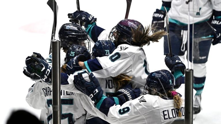 New York's Kayla Vespa leaps onto teammates as they celebrate the game winning goal of Alex Carpenter in overtime PWHL hockey action against Ottawa in Ottawa, on Sunday, Feb. 4, 2024. (Justin Tang/CP Photo)