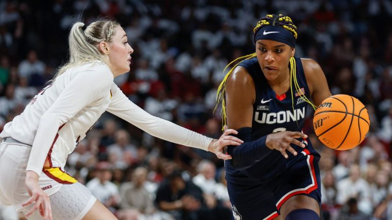 UConn forward Aaliyah Edwards, right, drives against South Carolina forward Chloe Kitts during the second half of an NCAA college basketball game in Columbia, S.C., Sunday, Feb. 11, 2024. (Nell Redmond/AP Photo)