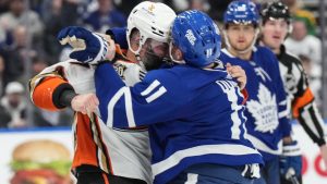 Anaheim Ducks' Radko Gudas, left, fights with Toronto Maple Leafs' Max Domi during first period NHL hockey action in Toronto, on Saturday, February 17, 2024. (Chris Young/CP)