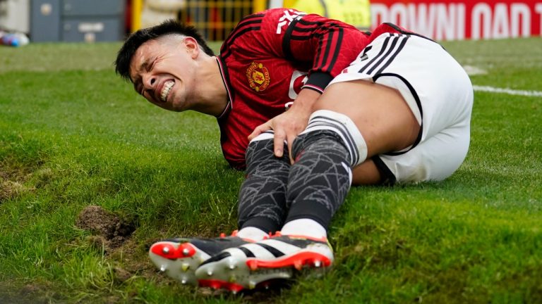 Manchester United's Lisandro Martinez grimaces in pain after an injury during the English Premier League soccer match between Manchester United and West Ham United. (Dave Thompson/AP)