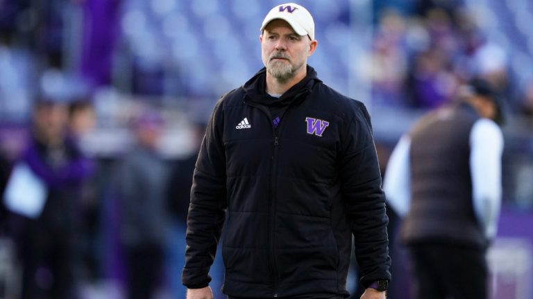 Ryan Grubb walks on the field before an NCAA college football game, Saturday, Nov. 25, 2023, in Seattle. (Lindsey Wasson/AP)