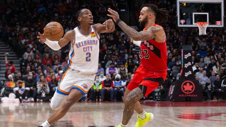 Oklahoma City Thunder's Shai Gilgeous-Alexander (left) drives at Toronto Raptors' Gary Trent Jr. during second half NBA basketball action. (Chris Young/CP)