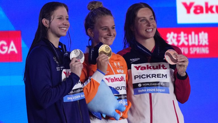 Gold medalist Tes Schouten of the Netherlands, centre, silver medalist Kate Douglass of the United States and bronze medalist Sydney Pickrem of Canada pose for a photo during the medal ceremony for the women's 200-meter breaststroke final at the World Aquatics Championships in Doha, Qatar, Friday, Feb. 16, 2024. (Lee Jin-man/AP)