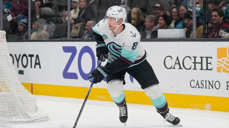 Seattle Kraken defenceman Brian Dumoulin (8) skates with the puck against the San Jose Sharks during the first period of an NHL hockey game in San Jose, Calif., Tuesday, Jan. 30, 2024. (Jeff Chiu/AP)