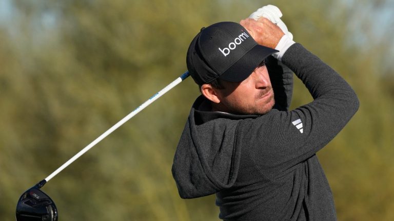 Nick Taylor, of Canada, hits his tee shot on the ninth hole during the continuation of the third round of the Phoenix Open golf tournament Sunday, Feb. 11, 2024, in Scottsdale, Ariz. (Ross D. Franklin/AP)