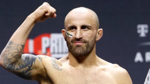 UFC featherweight champion Alexander Volkanovski raises a fist during a ceremonial weigh-in for UFC 290, Friday, July 7, 2023, in Las Vegas. (Steve Marcus/Las Vegas Sun via AP)