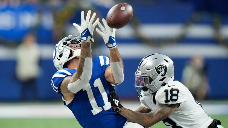 Indianapolis Colts wide receiver Michael Pittman Jr. (11) misses on a catch attempt next to Las Vegas Raiders cornerback Jack Jones (18) during the second half of an NFL football game Sunday, Dec. 31, 2023, in Indianapolis. (AJ Mast/AP) 
