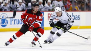 New Jersey Devils center Jack Hughes (86) skates around Los Angeles Kings center Jaret Anderson-Dolan (28) during the second period of an NHL hockey game Thursday, Feb. 15, 2024, in Newark, N.J. (AP Photo/John Munson)