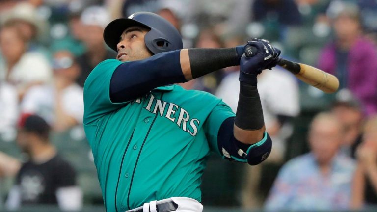 Seattle Mariners' Nelson Cruz watches his sacrifice fly during the first inning of the team's baseball game against the Chicago White Sox, Friday, July 20, 2018, in Seattle. (Ted S. Warren/AP Photo)