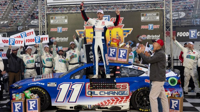 Denny Hamlin, center, celebrates after winning a NASCAR Cup Series auto race, Sunday, March 17, 2024, in Bristol, Tenn. (AP Photo/Wade Payne)