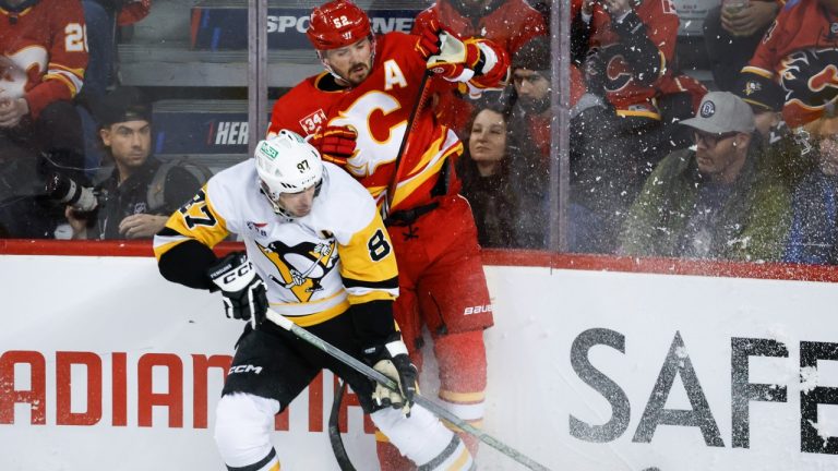 Pittsburgh Penguins forward Sidney Crosby (87) checks Calgary Flames defenceman MacKenzie Weegar (52) during first period NHL hockey action in Calgary, Saturday, March 2, 2024. (Jeff McIntosh/CP)