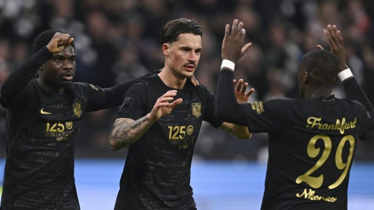 Frankfurt's Robin Koch, center, celebrates scoring with teammates Eric Junior Dina Ebimbe, left, and Niels Nkounkou during the Bundesliga soccer match between Eintracht Frankfurt and TSG 1899 Hoffenheim at Deutsche Bank Park in Frankfurt, Germany, Sunday March 10, 2024. (Arne Dedert/dpa via AP)