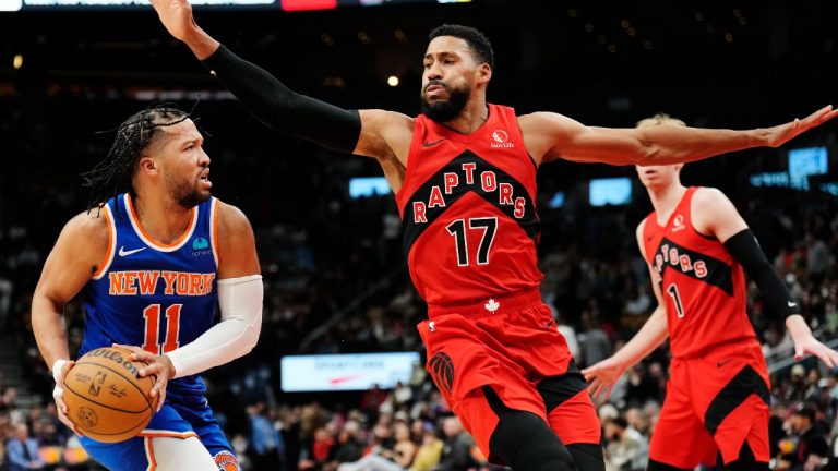 New York Knicks guard Jalen Brunson (11) looks to pass as Toronto Raptors forward Garrett Temple (17) defends during second half NBA basketball action in Toronto on Wednesday, March 27, 2024. (CP/Frank Gunn)