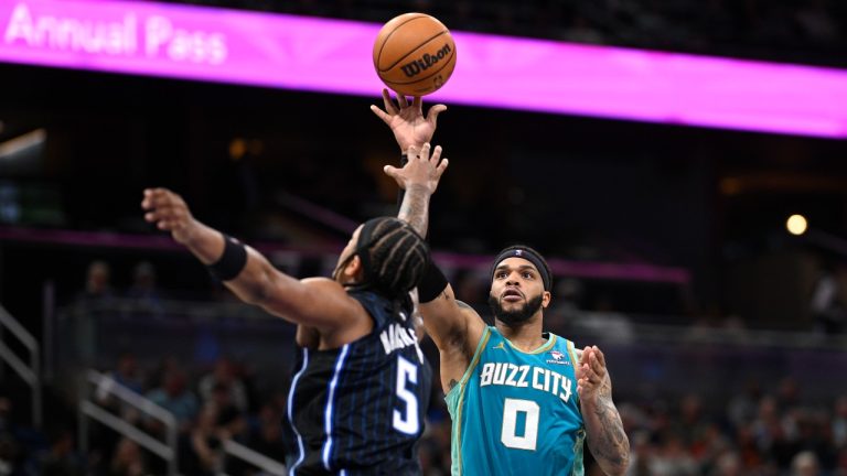 Charlotte Hornets forward Miles Bridges (0) shoots over Orlando Magic forward Paolo Banchero (5) during the second half of an NBA basketball game, Tuesday, March 19, 2024, in Orlando, Fla. (AP/Phelan M. Ebenhack)