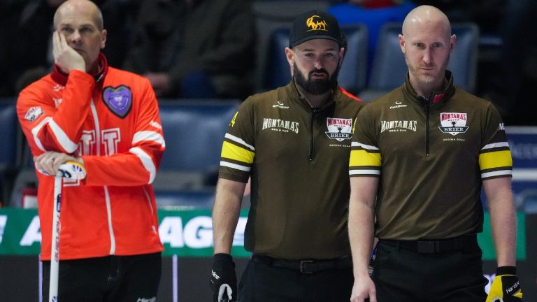 Manitoba-Carruthers third Reid Carruthers, centre, and skip Brad Jacobs, front right, discuss their next shot as Newfoundland and Labrador skip Andrew Symonds, back left, looks on during the Brier, in Regina, on Wednesday, March 6, 2024. (Darryl Dyck/CP)