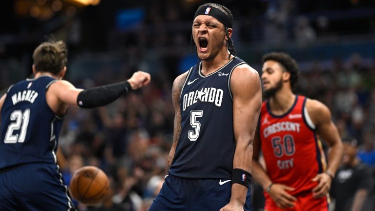 Orlando Magic forward Paolo Banchero (5) celebrates his dunk against the New Orleans Pelicans during the second half of an NBA basketball game Thursday, March 21, 2024, in Orlando, Fla. (AP Photo/Phelan M. Ebenhack)
