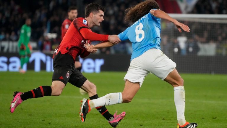 AC Milan's Christian Pulisic, left, stops Lazio's Matteo Guendouzi during the Italian Serie A soccer match between Lazio and Milan at Rome's Olympic stadium, Friday, March 1, 2024. (Gregorio Borgia/AP)