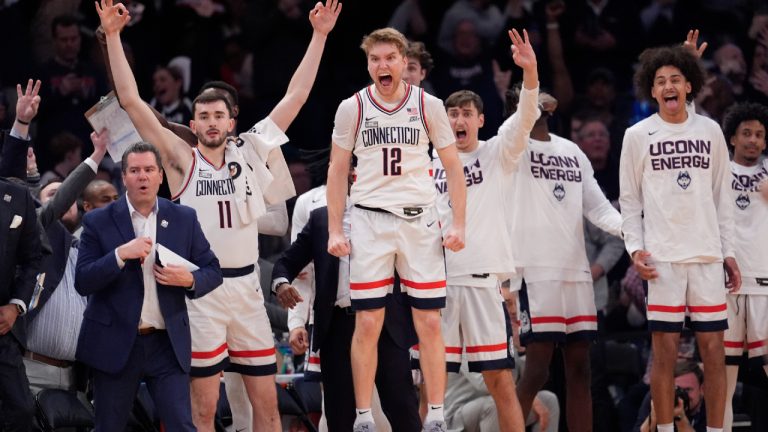 UConn guard Cam Spencer (12) and teammates celebrate during the final minutes of the team's NCAA college basketball game against Marquette for the championship of the Big East men's tournament Saturday, March 16, 2024, in New York. (Mary Altaffer/AP)