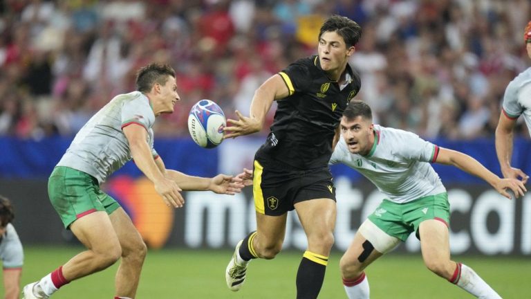 Wales' Louis Rees-Zammit, centre, passes the ball during the Rugby World Cup Pool C match between Wales and Portugal in the Stade de Nice, in Nice, France, Sept. 16, 2023. (Pavel Golovkin/AP Photo)