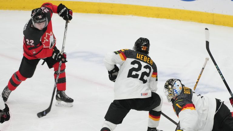 Canada's Jordan Dumais (22) scores on Germany goaltender Matthias Bittner (1) as Jakob Weber (22) defends during third period hockey action at the IIHF World Junior Hockey Championship in Gothenburg, Sweden, on December 31, 2023. (Christinne Muschi/CP)