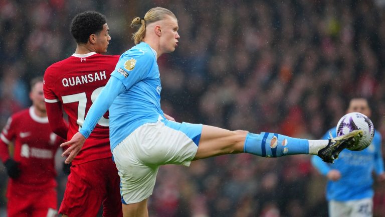 Manchester City's Erling Haaland, foreground, fights for the ball with Liverpool's Jarell Quansah during the English Premier League soccer match between Liverpool and Manchester City, at Anfield stadium in Liverpool, England, Sunday, March 10, 2024. (Jon Super/AP)