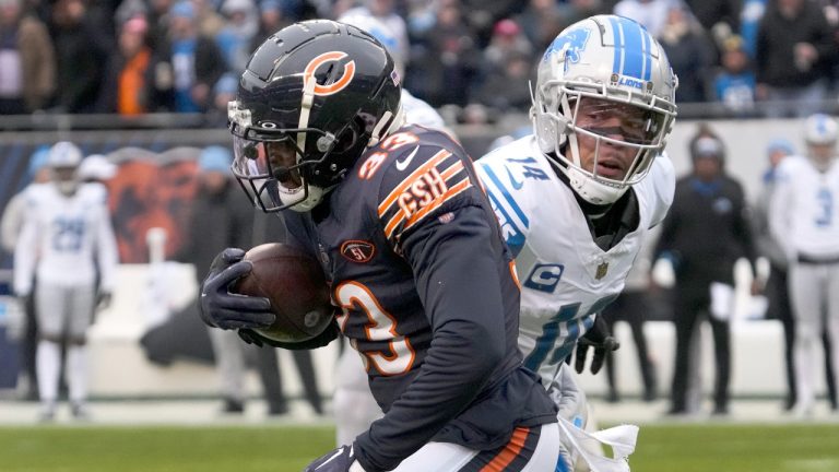 Chicago Bears cornerback Jaylon Johnson advances his interception of a Detroit Lions quarterback Jared Goff's pass as wide receiver Amon-Ra St. Brown watches during the first half of an NFL football game Sunday, Dec. 10, 2023, in Chicago. (Nam Y. Huh/AP)