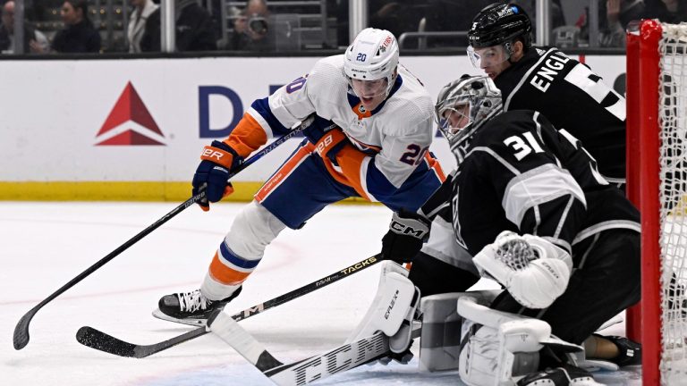 Los Angeles Kings goaltender David Rittich (31) deflects a shot by New York Islanders center Kyle Palmieri (21) with Kings defenseman Matt Roy (3) defending during the first period of an NHL hockey game in Los Angeles, Monday, March 11, 2024. (Alex Gallardo/AP)