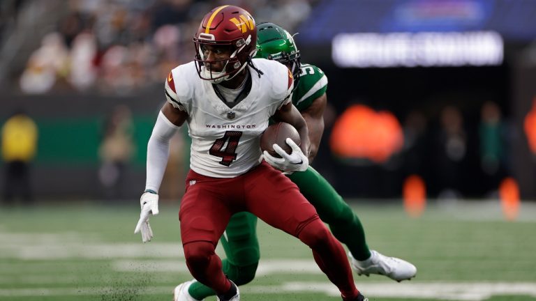 Washington Commanders wide receiver Curtis Samuel (4) carries the ball against the New York Jets during the second half of an NFL football game, Sunday, Dec. 24, 2023, in East Rutherford, N.J. (Adam Hunger/AP)