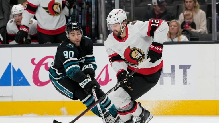 Ottawa Senators center Mark Kastelic (12) skates with the puck against San Jose Sharks right wing Justin Bailey (90) during the first period of an NHL hockey game in San Jose, Calif., Saturday, March 9, 2024. (Jeff Chiu/AP)