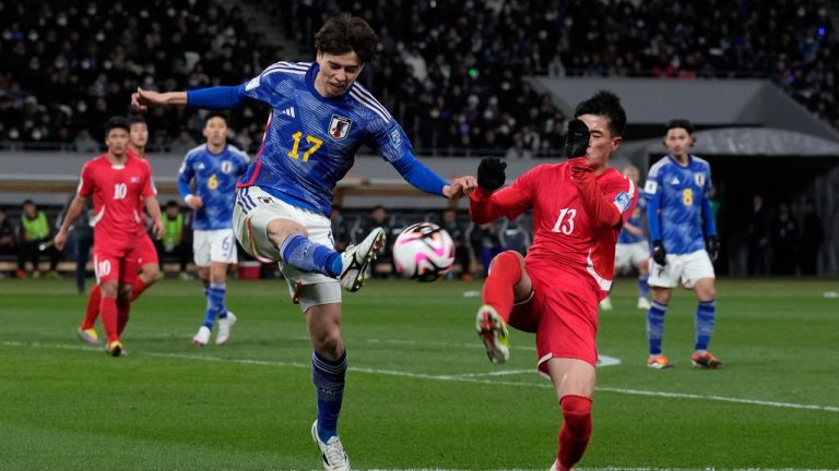 North Korea's Ri Il Song, right, competes for the ball with Japan's Ao Tanaka during the FIFA World Cup 2026 and AFC Asian Cup 2027 preliminary joint qualification round 2 match between Japan and North Korea at the National Stadium Thursday, March 21, 2024, in Tokyo. (Eugene Hoshiko/AP)