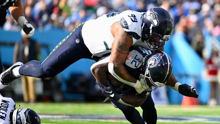 Seattle Seahawks defensive end Leonard Williams (99) tackles Tennessee Titans running back Tyjae Spears during the first half of an NFL football game on Sunday, Dec. 24, 2023, in Nashville, Tenn. (John Amis/AP)