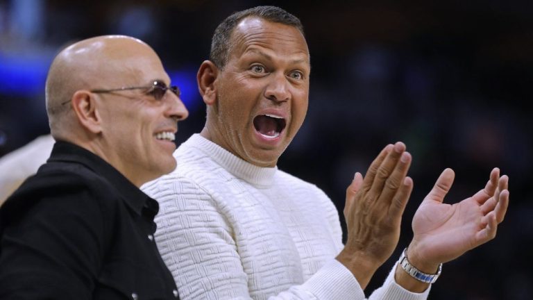 Minnesota Timberwolves and Lynx minority owners Marc Lore and Alex Rodriguez cheer as a call was overturned late in the fourth quarter of the team's NBA basketball game against the Atlanta Hawks on Friday, April 12, 2024, in Minneapolis. (Bruce Kluckhohn/AP Photo)
