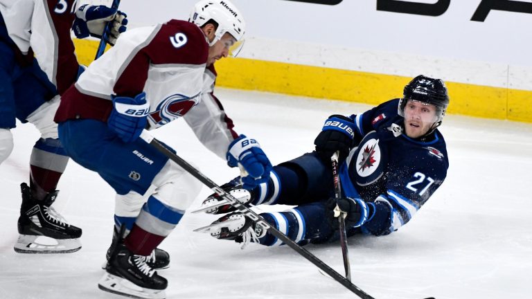 Winnipeg Jets' Nikolaj Ehlers (27) passes the puck past Colorado Avalanche's Zach Parise (9) during the first period in Game 5 of their NHL hockey Stanley Cup first-round playoff series in Winnipeg, Tuesday April 30, 2024. (Fred Greenslade/CP)