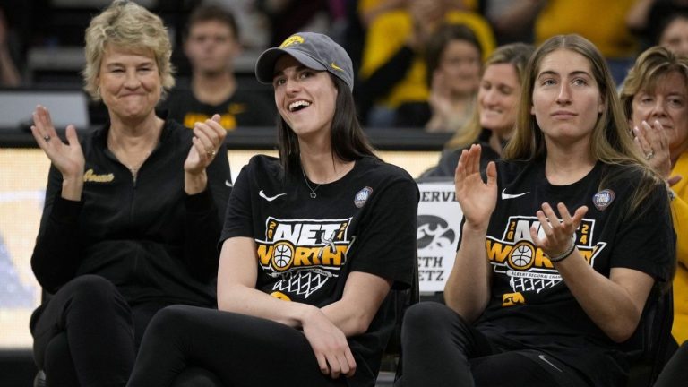 Iowa guard Caitlin Clark sits with coach Lisa Bluder and guard Kate Martin as she finds out her number will be retired, during an Iowa women's basketball team celebration Wednesday, April 10, 2024, in Iowa City, Iowa. (AP Photo/Charlie Neibergall)