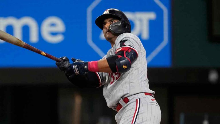 Minnesota Twins' Donovan Solano watches the flight of his home run during a baseball game against the Texas Rangers, Saturday, Sept. 2, 2023, in Arlington, Texas. (Tony Gutierrez/AP)
