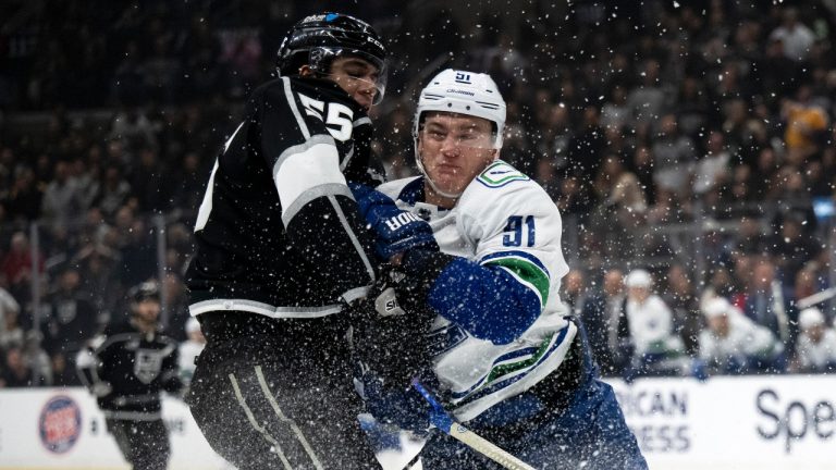 Vancouver Canucks defenseman Nikita Zadorov (91) checks Los Angeles Kings right wing Quinton Byfield (55) during the second period of an NHL hockey game Tuesday, March 5, 2024, in Los Angeles. (AP Photo/Kyusung Gong) 