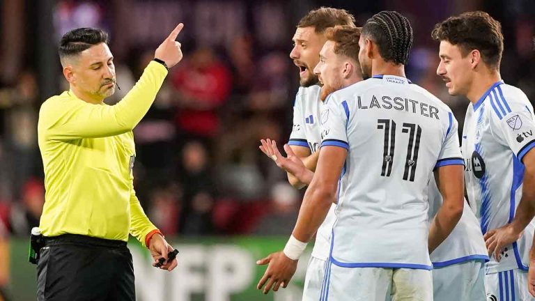 Referee Ramy Touchan issues a red card to CF Montreal center back Joel Waterman, which was later overturned on review, during the second half of an MLS soccer match against D.C. United, Saturday, March 30, 2024, in Washington. (Nathan Howard/AP)