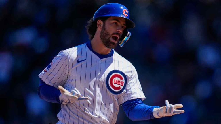 Chicago Cubs' Dansby Swanson signals to the dugout as he runs the bases after hitting a home run during the second inning of a baseball game against the Los Angeles Dodgers, Friday, April 5, 2024, in Chicago. (Erin Hooley/AP)