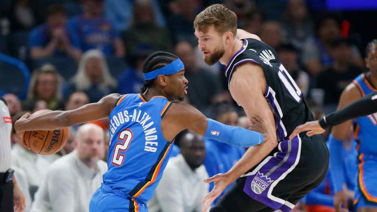 Oklahoma City Thunder guard Shai Gilgeous-Alexander (2) is defended by Sacramento Kings forward Domantas Sabonis during the first half of an NBA basketball game Tuesday, April 9, 2024, in Oklahoma City. (Nate Billings/AP)